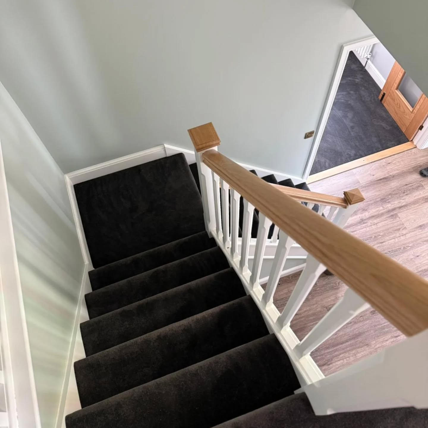 Freshly cleaned carpeted stairs and banister after building work